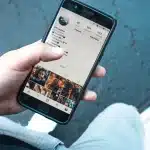 Personne partageant un message personnel sur les réseaux sociaux depuis son téléphone